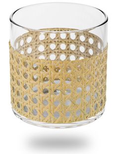 a glass vase with holes in it on a white background, filled with small circles