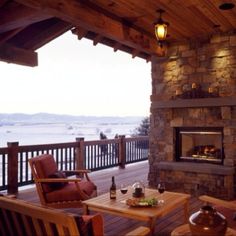 an outdoor fireplace and seating area on a deck