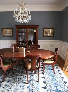 a dining room table with chairs and a chandelier