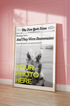 the new york news and they were roommates poster in front of a pink wall