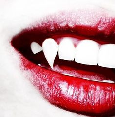 a woman's mouth with white teeth and red lipstick