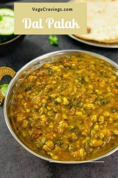 a bowl filled with soup next to some pita bread