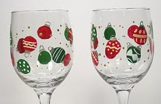 two wine glasses with ornaments painted on them