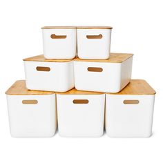 six white storage bins stacked on top of each other with wooden handles and lids