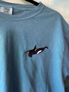 "Original Design Embroidered Orca T-Shirt! Lots of different color choices and sizes, this shirt is designed to be for Unisex but the sizing is in Men's, just check out the size chart and order accordingly! This Embroidered Orca Whale Comfort Colors shirt is part of my \"Ocean Creature Shirts\" collection. OTHER SHIRTS YOU MIGHT LIKE: LOOKING FOR THE SWEATSHIRT VERSION? https://www.etsy.com/listing/1601795282/orca-whale-embroidered-gildan-sweatshirt Interested in Embroidered Mom and Baby Orca shirt? See my other listing here: https://www.etsy.com/listing/1516341946/orca-whale-embroidered-bella-canvas Embroidered Orca Whales Mom of Two Comfort Colors Shirt: https://www.etsy.com/listing/1586621759/mom-of-two-embroidered-orca-shirt-orca If you're looking for a thick, structured tee that's als Whale Tee Shirt, Casual Crew Neck T-shirt With Custom Embroidery, Relaxed Fit Crew T-shirt With Custom Embroidery, Custom Embroidered Relaxed Fit Crew T-shirt, Blue Embroidered Crew T-shirt, Casual Tops With Custom Embroidery And Relaxed Fit, Casual Long Sleeve Shirt With Custom Embroidery, Casual Tops With Custom Embroidery In Relaxed Fit, Casual Long Sleeve Shirt With Embroidered Logo