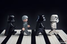 lego star wars figures are lined up on a piano keyboard with black and white stripes