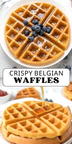 two waffles with syrup being drizzled over them and topped with blueberries