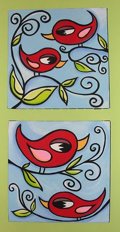 two red birds sitting on top of a blue and green wall next to each other