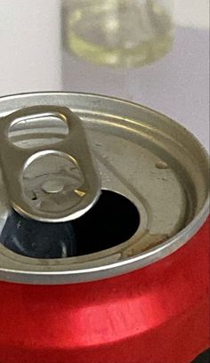 an open can of soda sitting on top of a table