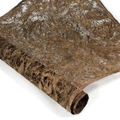 a roll of brown fabric on top of a white surface with an animal print pattern