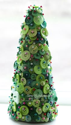 a green christmas tree made out of buttons