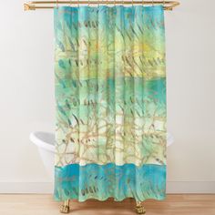 a shower curtain with blue and green paint on it, in front of a white bath tub