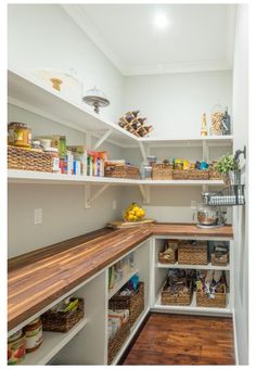 an organized pantry with lots of shelves and baskets on the top shelf, along with other items