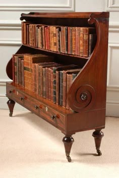 an old wooden bookcase with many books on it's sides and two drawers