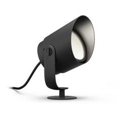 a black lamp with a white light on top of it and a cord attached to the side