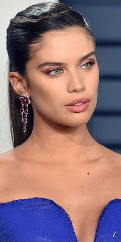 a close up of a person wearing a blue dress