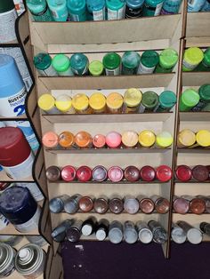 the shelves are filled with many different types of paint