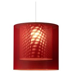 a red lamp shade hanging from a ceiling