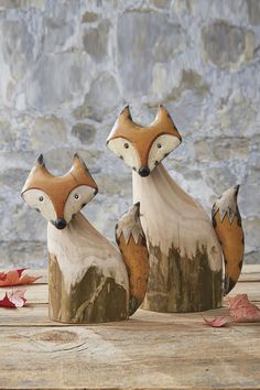 three wooden foxes sitting on top of each other