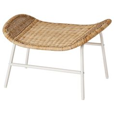 a wicker bench sitting on top of a white frame