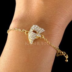 "PERFECT CHRISTMAS GIFT FOR LADIES!! You are getting a dainty, Phantom of the Opera Half Mask Bracelet with Swarovski crystal attached to fine cable original rhodium plated Gold tone chain. Charm size is 5/8\" wide X 5/8\" high (15mm X 15mm) Color (Standard Swarovski Color Names): Crystal Clear The bracelet measures 6 1/2\" long (16.5cm) with 2\" extension chain (5cm). Prices are in US$. For shipping policies and other important information, click on \"profile\" on the right. See an item that yo Gold Christmas Party Bracelets, Gold Jewelry For New Year Party, Gold Jewelry For New Year's Party, 40 Birthday Gifts, Broadway Show, Pretty Jewelry Necklaces, Mother Christmas Gifts, Masquerade Mask, Jewelry Lookbook