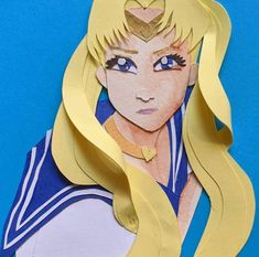 paper cutout of sailor girl with long blonde hair and blue eyes, on a blue background