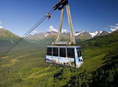 a cable car going up the side of a mountain