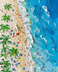 an aerial view of a beach with palm trees and people in the water, from above