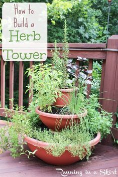 three clay pots filled with herbs on top of a wooden deck next to a sign that says how to build a herb tower