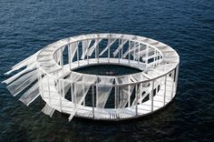 a circular structure floating on top of the ocean