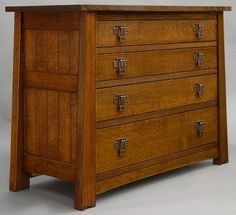 a wooden dresser with four drawers on one side and two doors at the other end