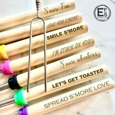 six wooden mallets are lined up in a row with the words,'let's get toasted'written on them