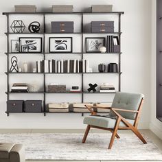 a living room filled with furniture and bookshelves next to a wall mounted book shelf