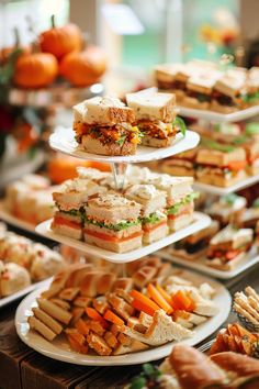 there are many different sandwiches on the trays that are stacked high in the air