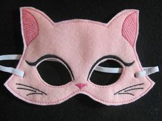 a pink cat mask with black eyes