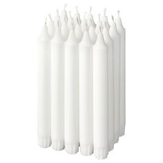 six white candles are lined up in a row