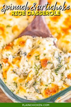 a casserole dish with cheese and spinach in it on a wooden spoon