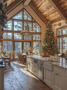 a kitchen with a christmas tree in the center and lots of windows on both sides