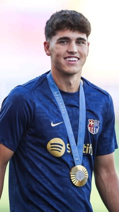 a young man with a medal around his neck