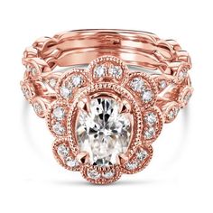 a rose gold engagement ring with an oval center surrounded by round diamonds