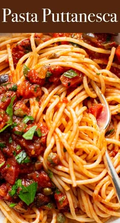 a plate of pasta with tomato sauce and basil