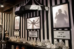 there is a display in the store with glassware and shadow images on the wall