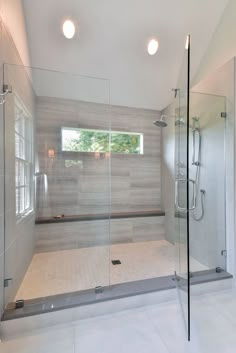 a bathroom with a walk in shower next to a window