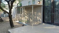 a house that has a fence in front of it and some trees near the door