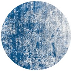 a round rug with blue and white paint on it