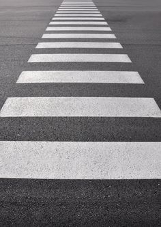 an empty street with white lines painted on the pavement stock images, black and white photography, crosswalks