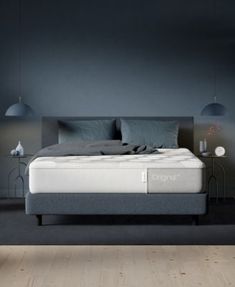 an image of a bedroom setting with mattress and night stand