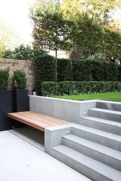 a wooden bench sitting on top of cement steps