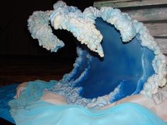 a cake shaped like a wave with icing on it