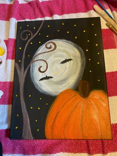 an acrylic painting of a pumpkin and a full moon on a striped blanket